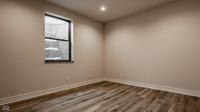 empty room with wood-type flooring and a wealth of natural light