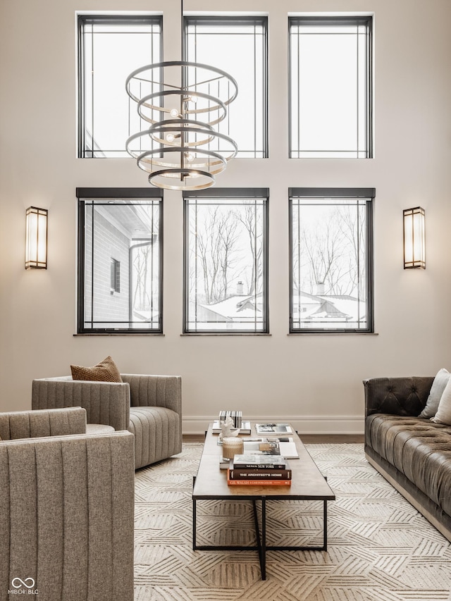 living room with a notable chandelier and light hardwood / wood-style flooring