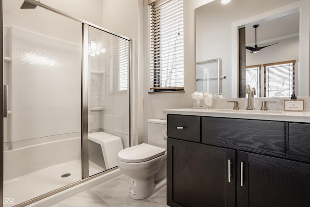 bathroom with ceiling fan, toilet, a shower with door, and vanity