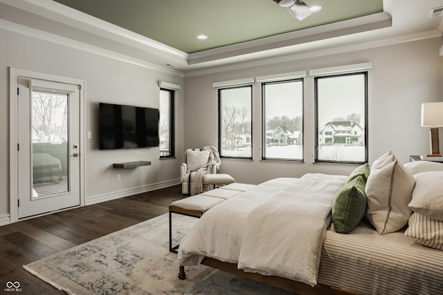 bedroom with access to outside, dark hardwood / wood-style flooring, crown molding, and a tray ceiling