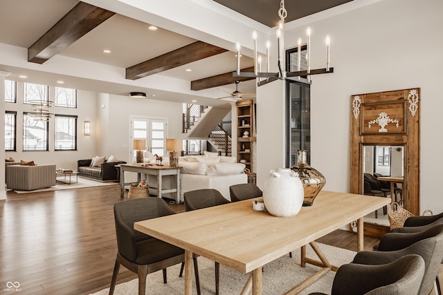 dining area featuring beam ceiling and wood-type flooring