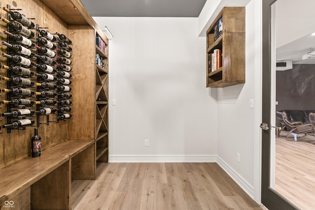 wine area with light hardwood / wood-style flooring