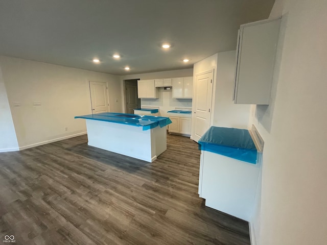 kitchen featuring recessed lighting, a kitchen island, white cabinetry, baseboards, and dark wood-style floors