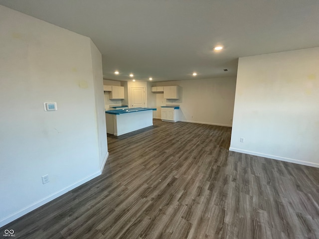 unfurnished living room with dark hardwood / wood-style floors