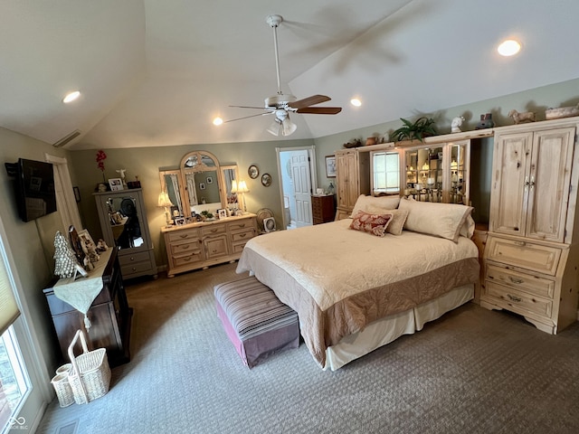 bedroom featuring dark carpet, vaulted ceiling, and ceiling fan