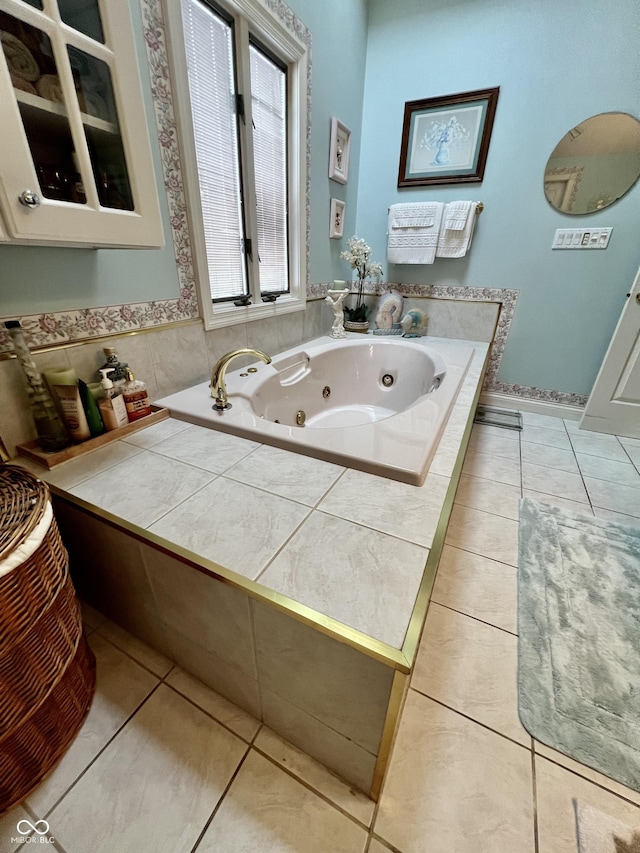 bathroom featuring tile patterned flooring and tiled bath