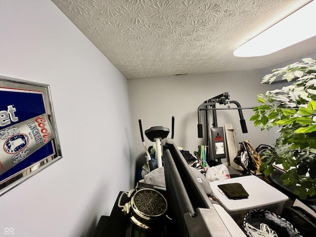 workout area with a textured ceiling