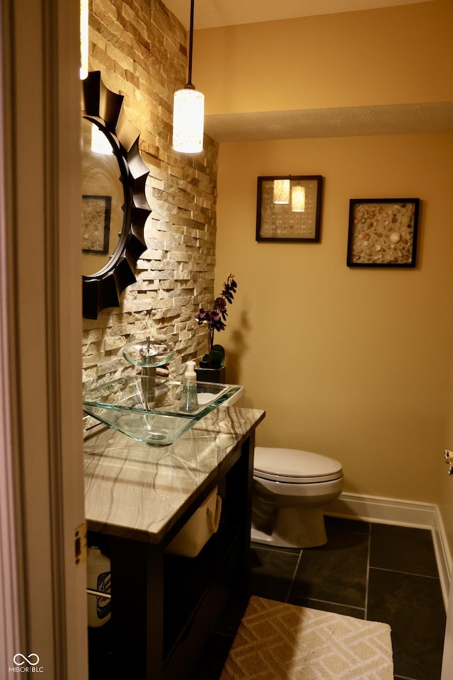 bathroom with vanity, tile patterned floors, and toilet