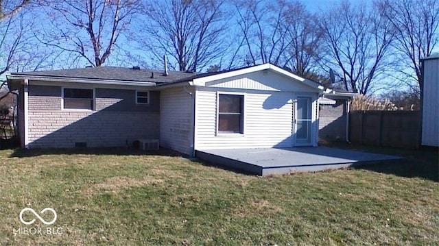 rear view of property featuring a yard and central AC