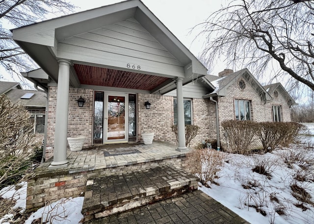 view of snow covered property entrance