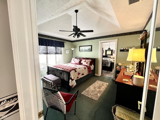 carpeted bedroom with a textured ceiling and ceiling fan