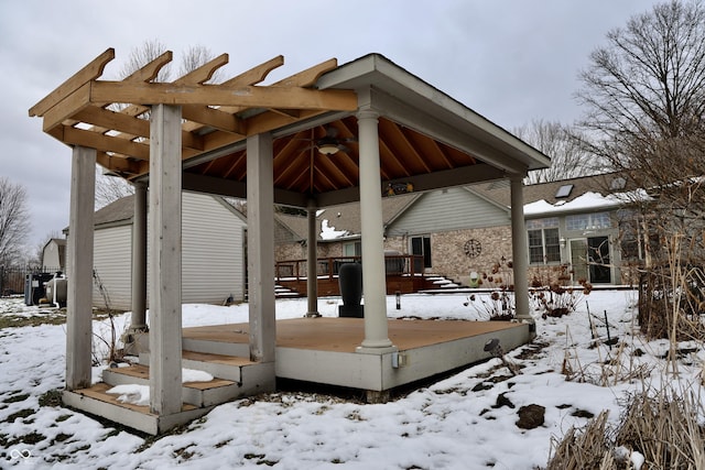 snow covered patio with a gazebo and a deck