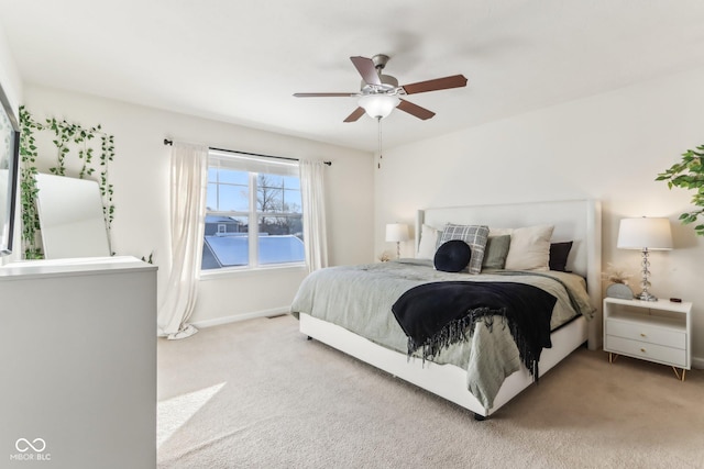 bedroom featuring light carpet and ceiling fan