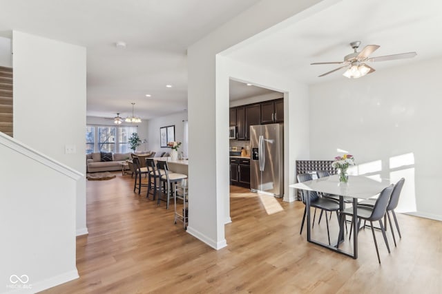 dining area featuring ceiling fan and light hardwood / wood-style floors