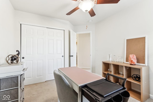 carpeted office space with ceiling fan