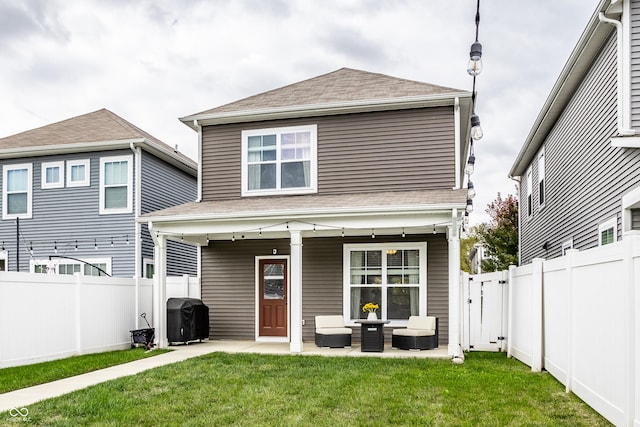 back of property featuring an outdoor hangout area, a patio, and a yard