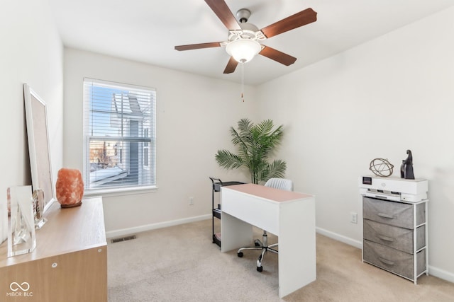 carpeted office featuring ceiling fan