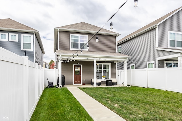 rear view of property with cooling unit, a yard, and a patio