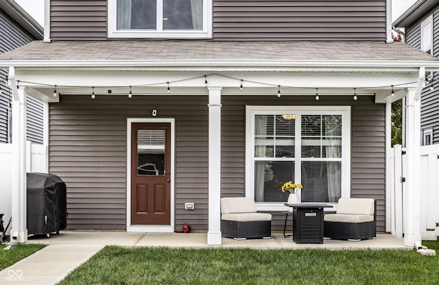 entrance to property featuring a lawn