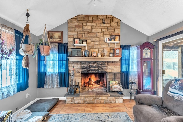 living room featuring lofted ceiling, a fireplace, and wood-type flooring