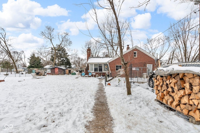 view of snow covered back of property