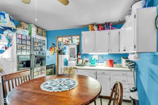 kitchen with ceiling fan, white cabinets, and electric panel