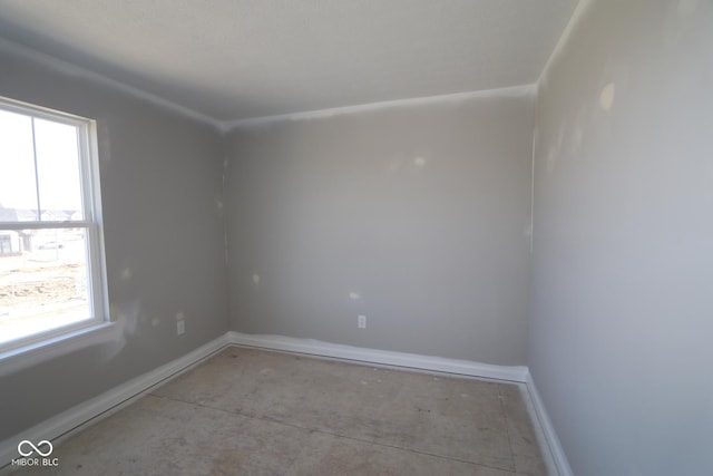 unfurnished room featuring baseboards