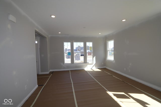 unfurnished room featuring recessed lighting, baseboards, and wood finished floors