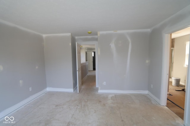 spare room featuring baseboards