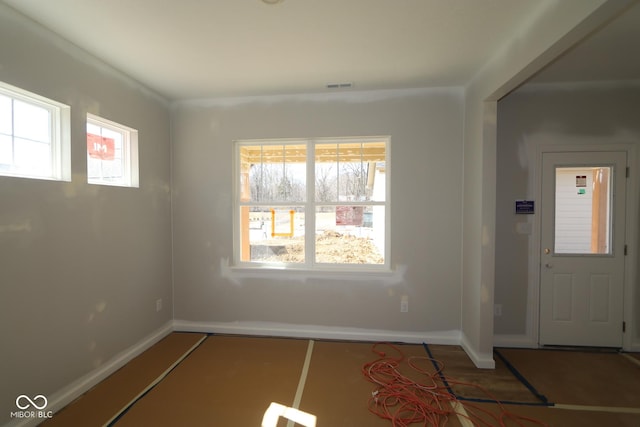 foyer with visible vents, baseboards, and wood finished floors