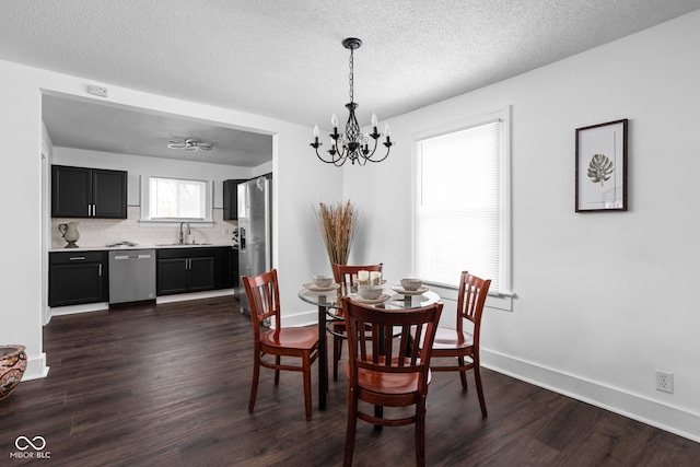 dining room with dark wood-type flooring, a chandelier, and a healthy amount of sunlight