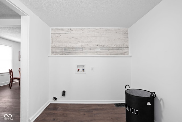 clothes washing area featuring washer hookup, a textured ceiling, and dark hardwood / wood-style floors