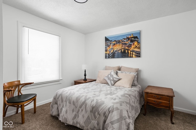 bedroom with a textured ceiling and carpet floors