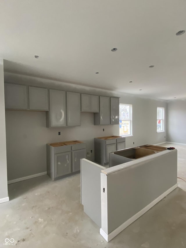 kitchen with a kitchen island and gray cabinetry