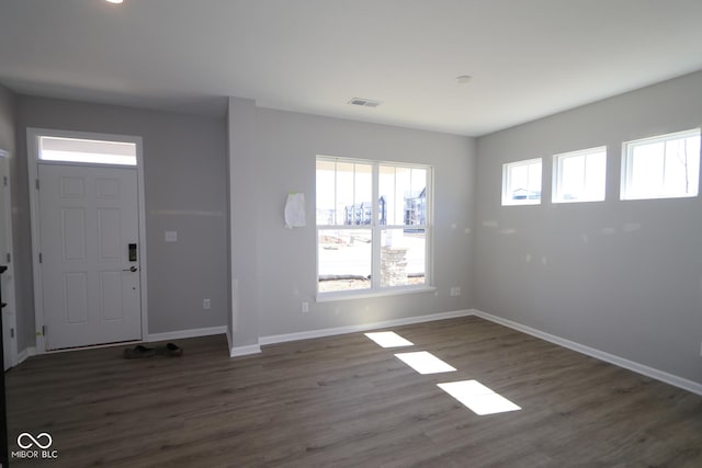 entryway featuring dark wood-type flooring, baseboards, and visible vents