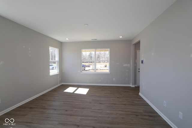 empty room with recessed lighting, baseboards, and dark wood-style floors