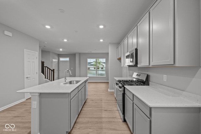 1721 Real St, Indianapolis, IN 46240 - kitchen with appliances with stainless steel finishes, a sink, gray cabinetry, light wood-style floors, and recessed lighting