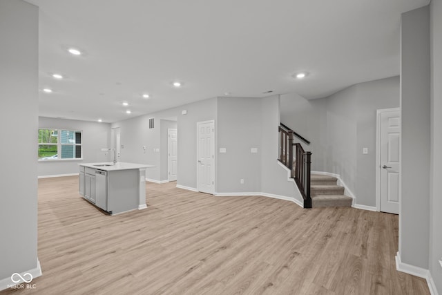 1721 Real St, Indianapolis, IN 46240 - kitchen featuring recessed lighting, light wood-style floors, an island with sink, baseboards, and light countertops