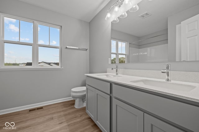1721 Real St, Indianapolis, IN 46240 - bathroom featuring toilet, baseboards, wood finished floors, a shower, and double vanity