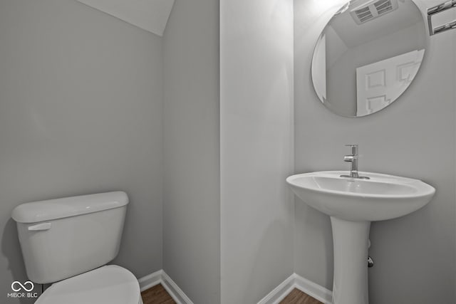 1721 Real St, Indianapolis, IN 46240 - bathroom with toilet, wood finished floors, and baseboards