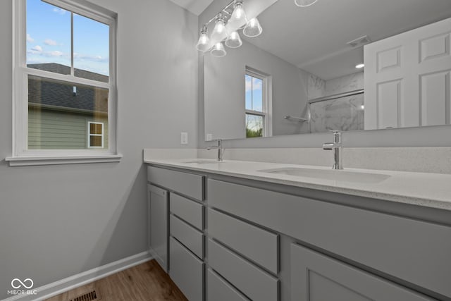 1721 Real St, Indianapolis, IN 46240 - full bathroom featuring a marble finish shower, wood finished floors, double vanity, and baseboards
