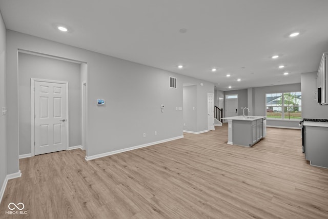 1721 Real St, Indianapolis, IN 46240 - kitchen featuring gray cabinetry, light wood-type flooring, recessed lighting, a sink, and an island with sink