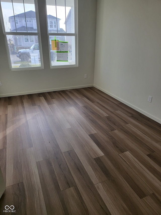 empty room featuring dark hardwood / wood-style flooring