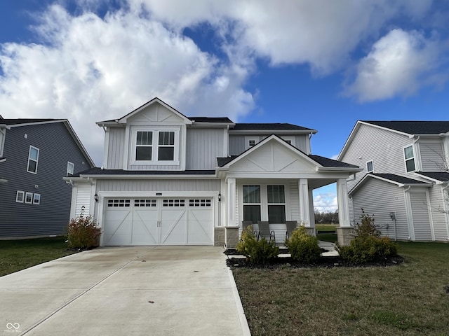 craftsman-style home with covered porch, a front lawn, and a garage