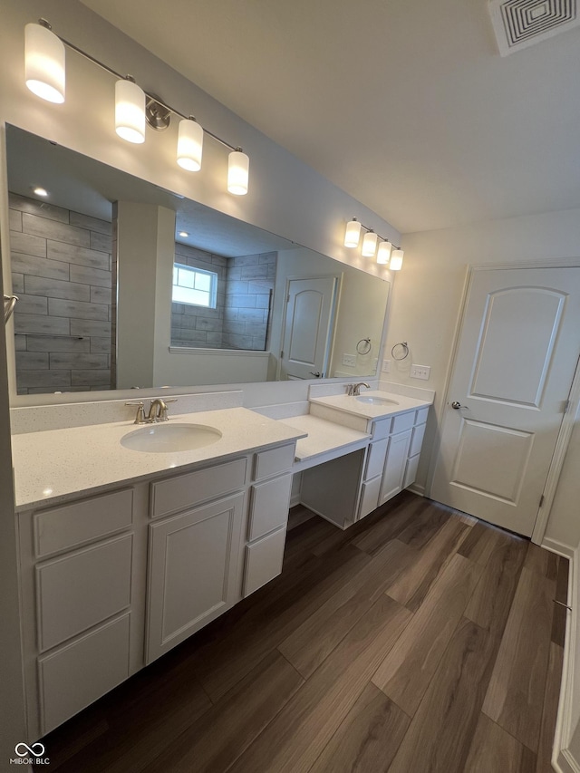 bathroom featuring walk in shower, wood-type flooring, and vanity