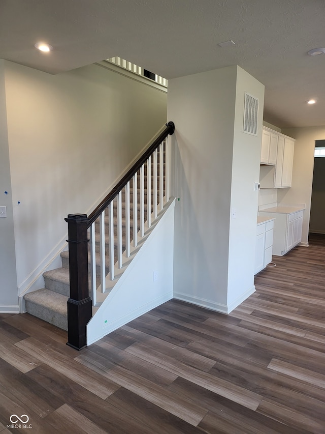 staircase featuring wood-type flooring