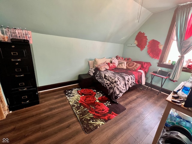 bedroom with dark hardwood / wood-style flooring and vaulted ceiling