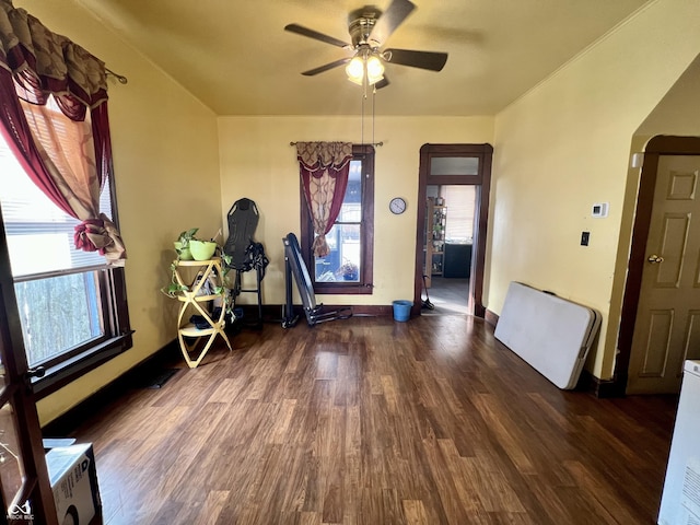 interior space featuring ceiling fan and dark hardwood / wood-style floors