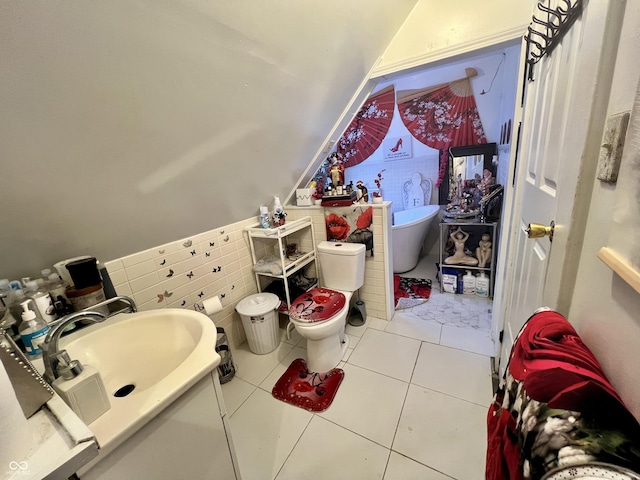 bathroom with sink, tile patterned flooring, tile walls, and toilet