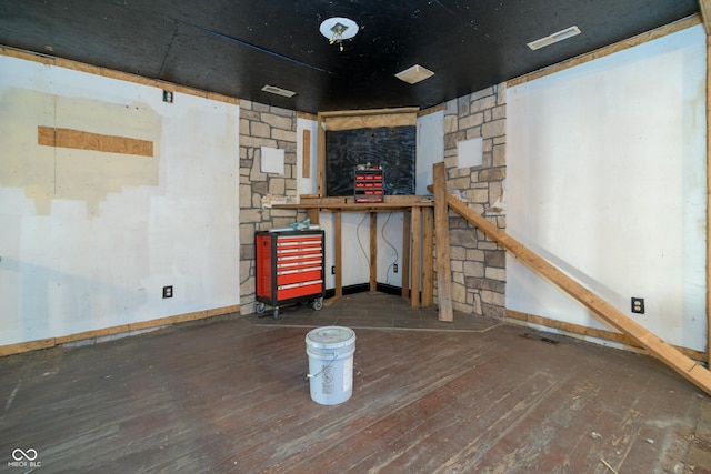 basement with dark hardwood / wood-style floors